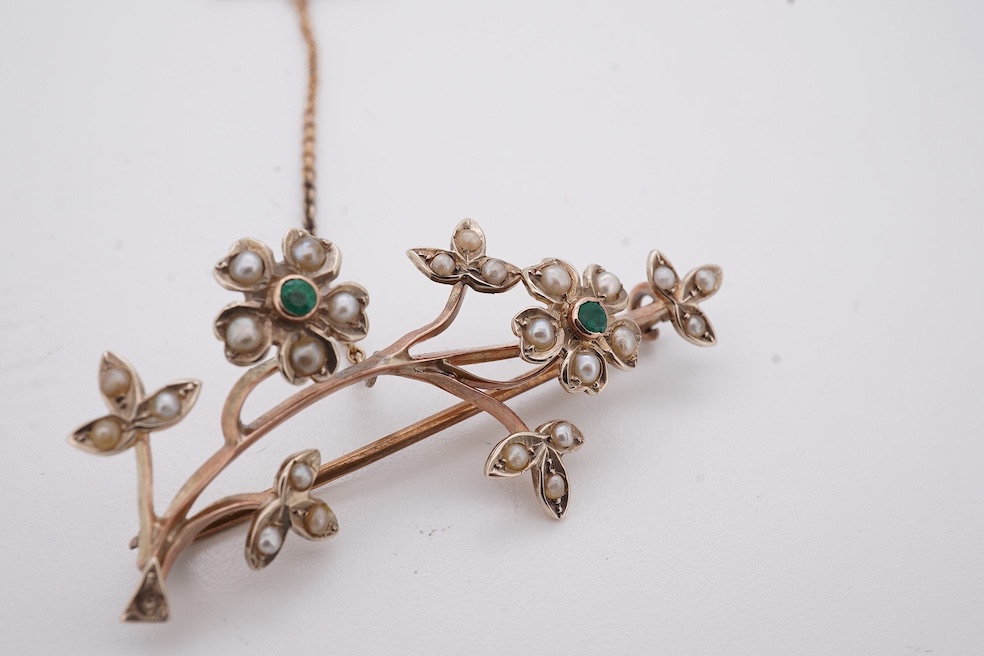 An early 20th century 9ct, seed pearl and emerald cluster set floral spray brooch, 45mm, gross weight 4.4 grams. Condition - poor to fair